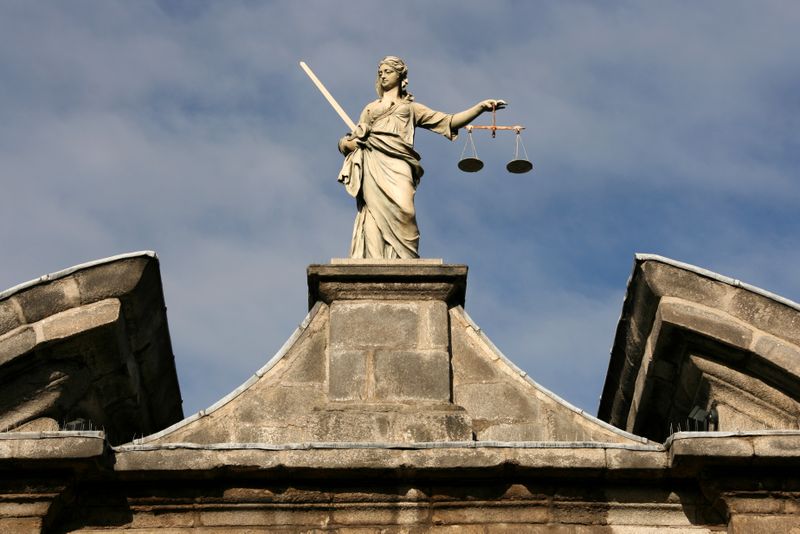 Statue Themis Goddess of justice on top of court building