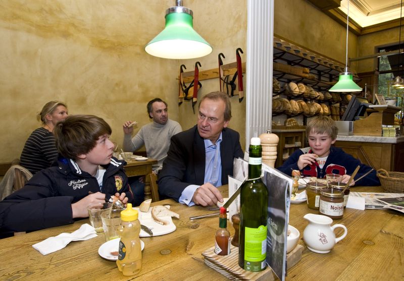 Father and sons having breakfast in coffee shop