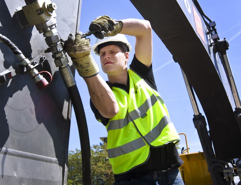 Engineer working on tightening bolts on a pipe