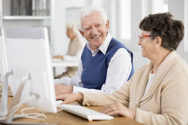 Retirees learning computer skills