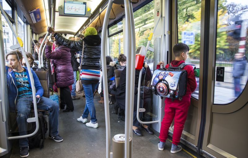 People standing and sitting on public transport