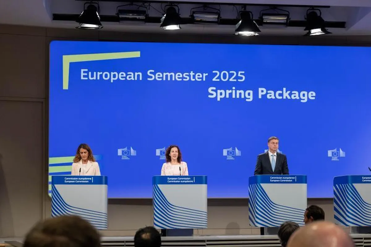Three speakers at a podium in a conference room discuss the European Semester 2025 Spring Package, with attendees seated in the audience.