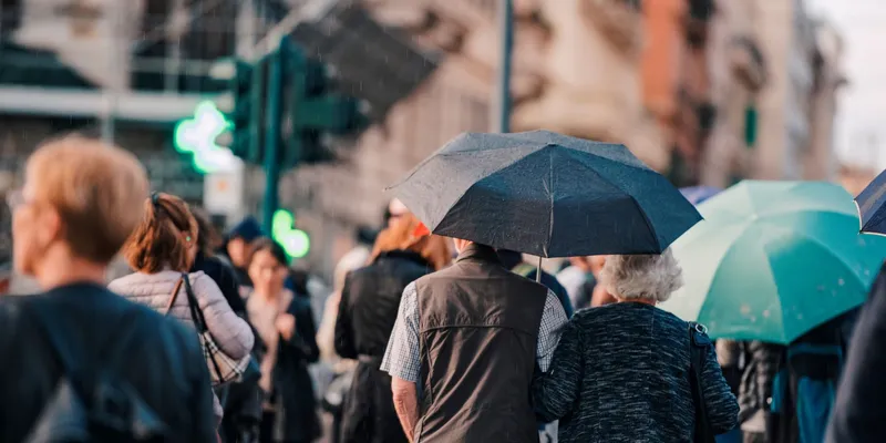 People walking through the streets of Rome on a rainy day by agcreativelab / Adobe Stock