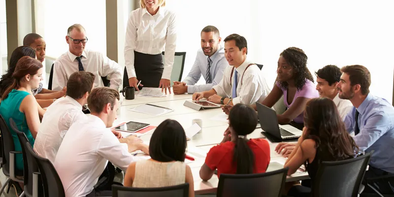 Group of people sitting around a table at the office