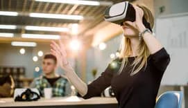 Woman using VR headset in office