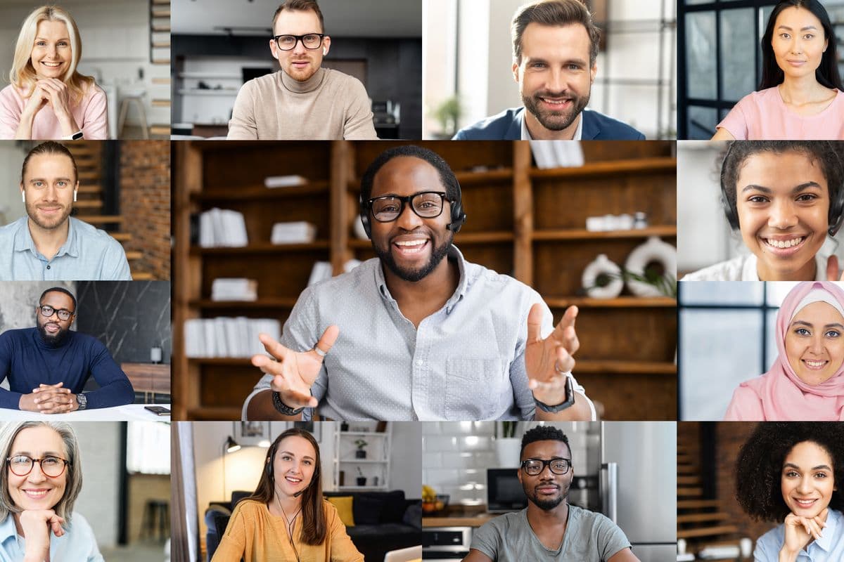 Confident African male business coach holding online webinar, a group of diverse people involved. Online video meeting of multinational work team, video call screen with a many people profiles on it