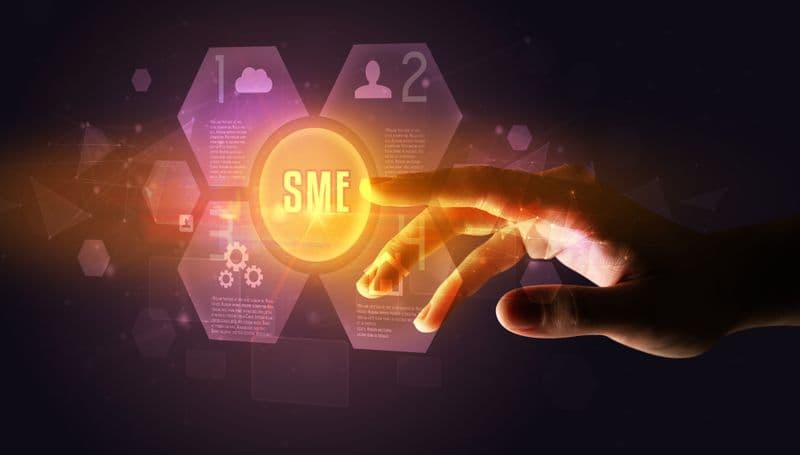 A hand reaching towards a glowing "SME" button, surrounded by digital hexagonal icons on a dark background.