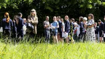 A group of people, including students, stand outside engaging with the activities during the Eurofound open day 2026